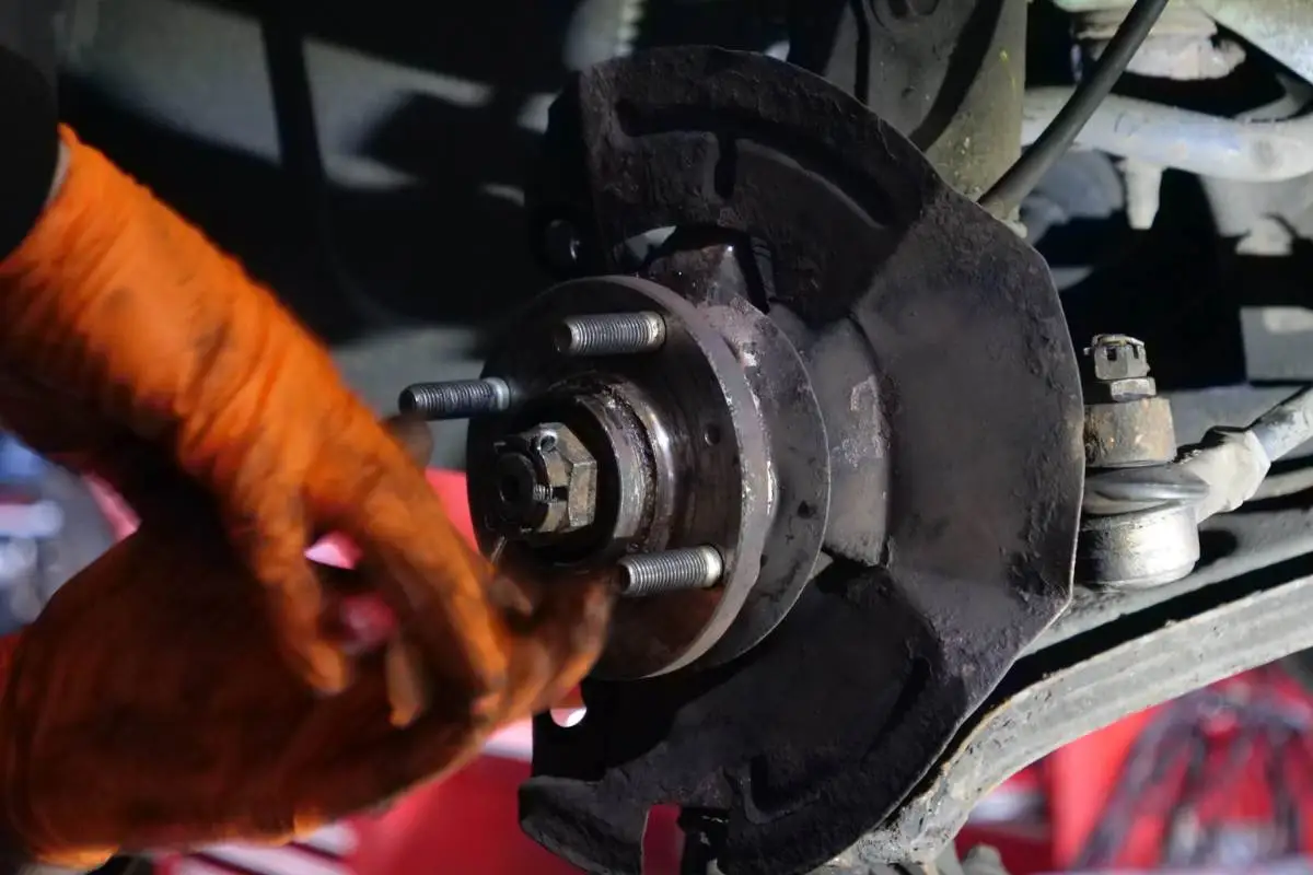 Technician inspecting brake pads and brake discs at Hyde Road Wheels & Tyres in Manchester