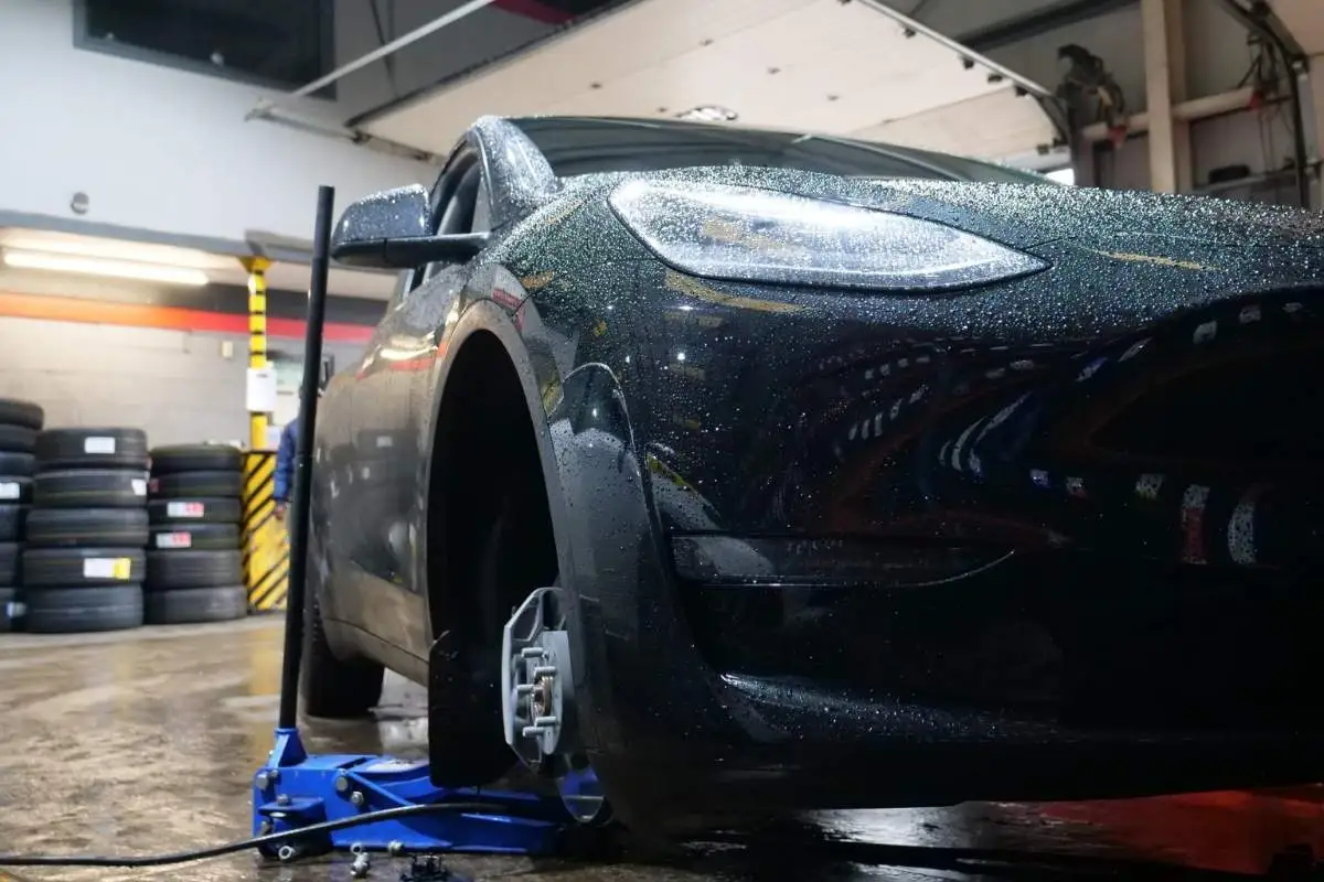 echnician checking wheel alignment on a vehicle at Hyde Road Wheels & Tyres in Manchester